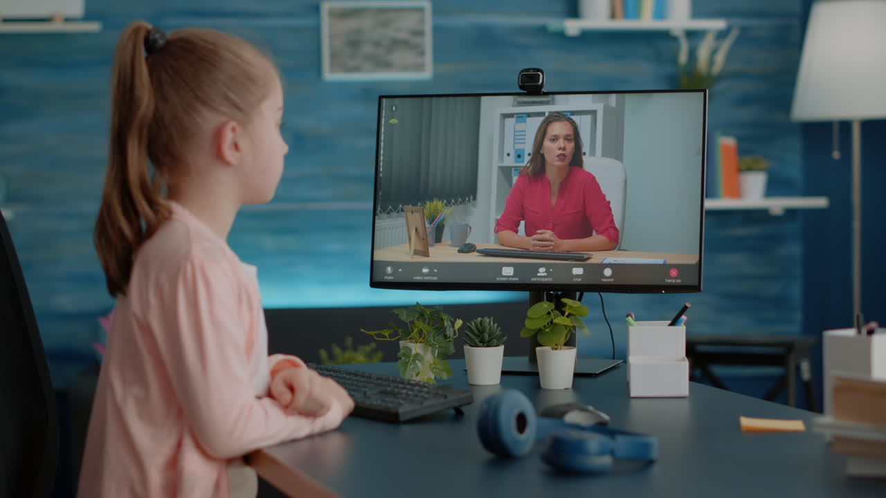 Little girl using video call for online remote lesson with teacher