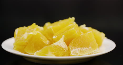 Extreme-Close-Up-Of-Sliced-Orange-Rotating-On-Plate