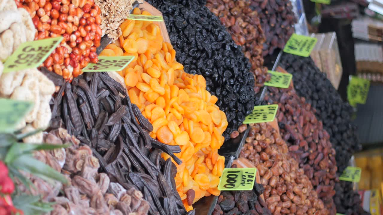 Vibrant display of various dried fruits and nuts at a market