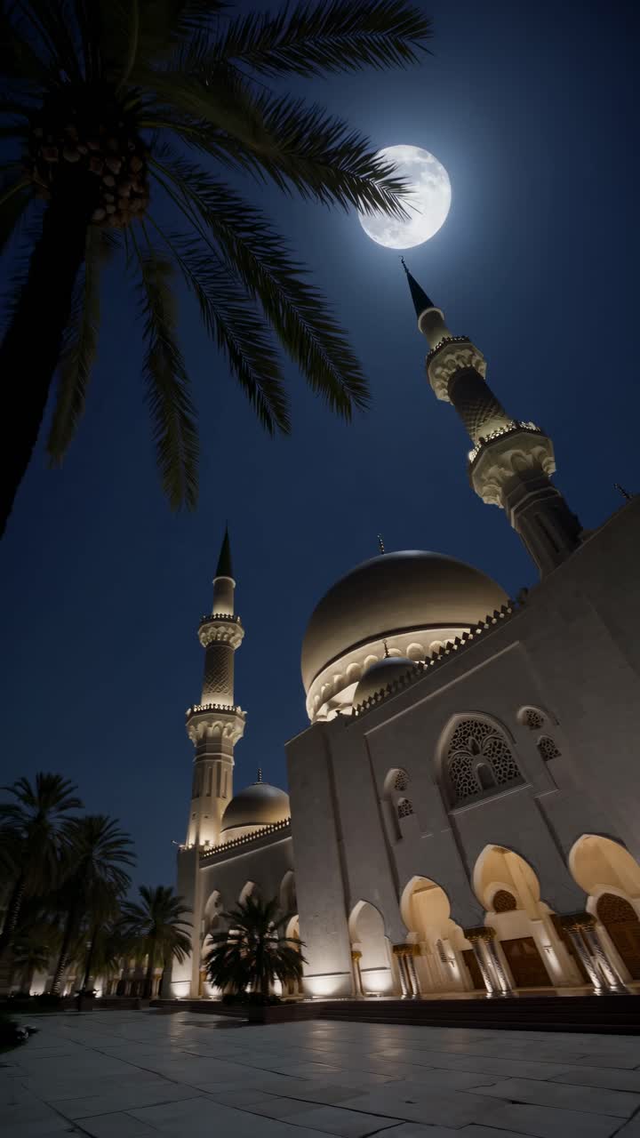 A stunning low-angle video capture of a mosque at night, with a full moon illuminating the sky