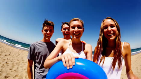 smiling young friends enjoying a sunny day at the beach