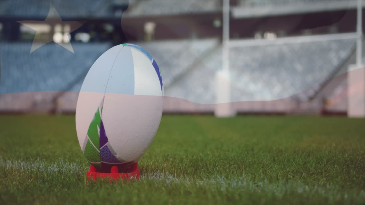 Rugby ball on tee in stadium with animation of flag overlaying background