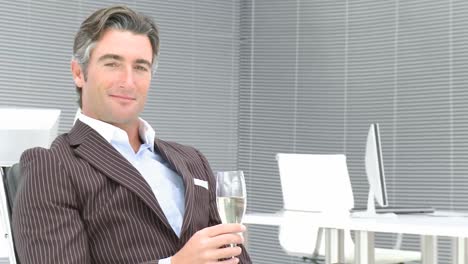 Business-manager-drinking-champagne-in-office