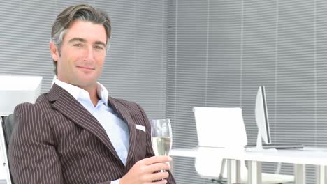 business manager drinking champagne in office