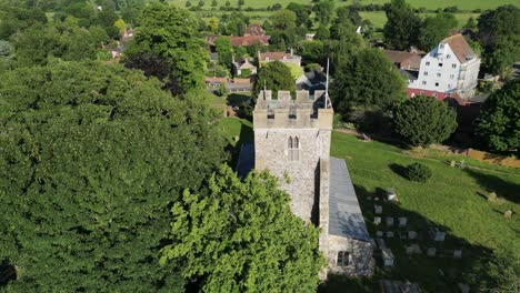 a rising pedestal shot over trees and st andrew's church in wickhambreaux