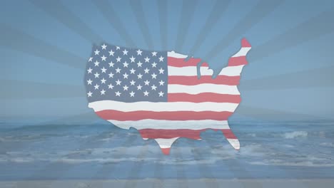 american flag waving over us map over radial stripes against view of the beach