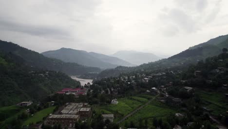 aerial shot of town along with jehlum river, muzaffarabad ajk