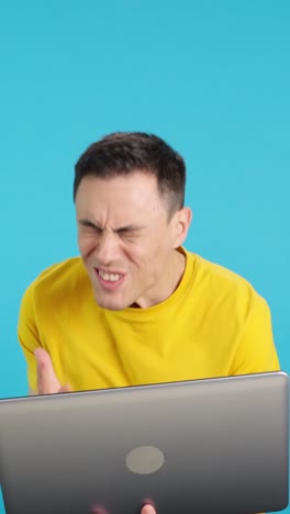 man looking concerned at a laptop