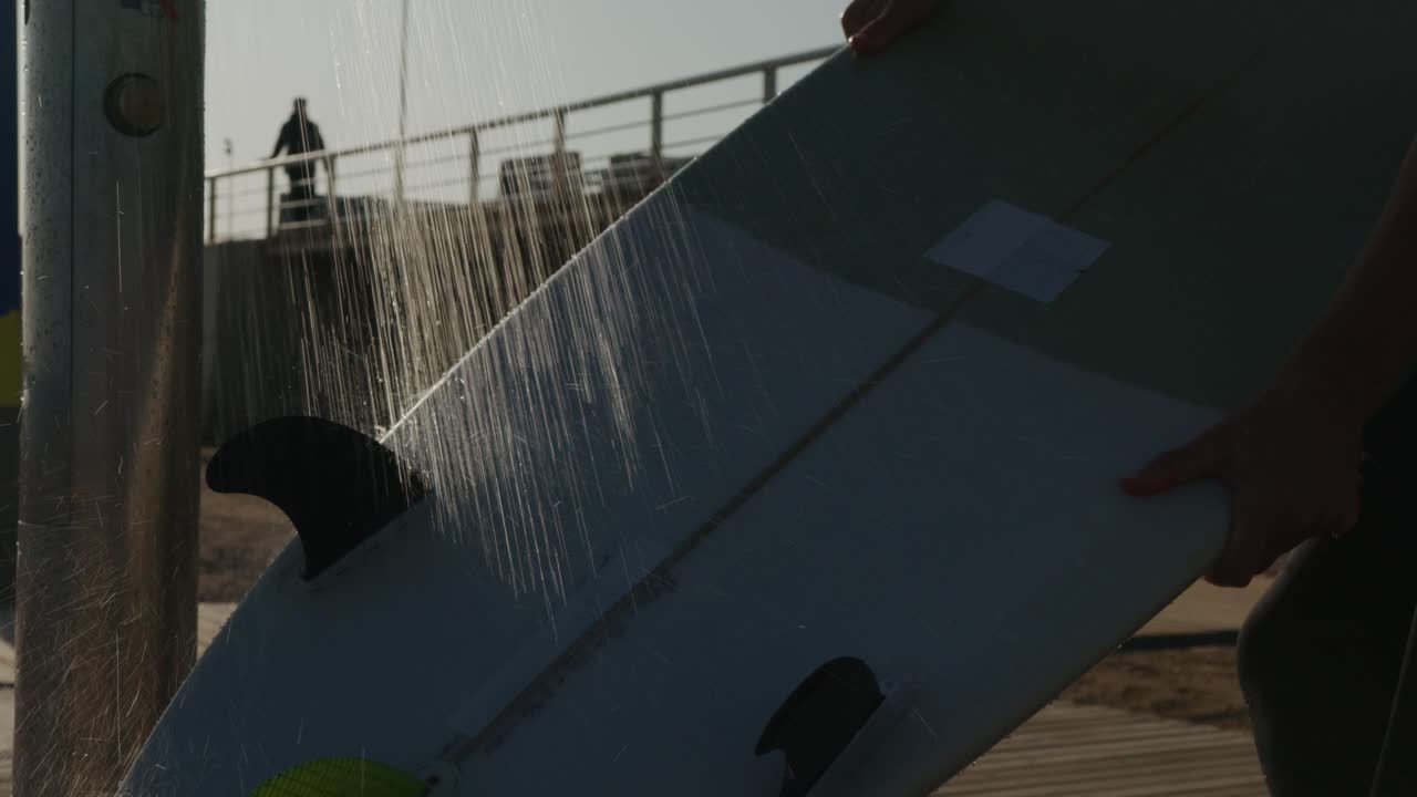 Surfer man walking to the beach at sunset preparing for surfing training and search for waves in Barcelona, spain, water, ocean exercise in sea with board, athletic male holiday or travel in vacation