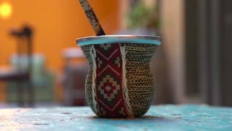 pouring hot water in argentinian mate tea cup with traditional design