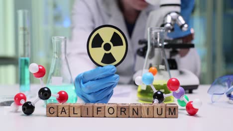 scientist with californium and radiation symbol in laboratory