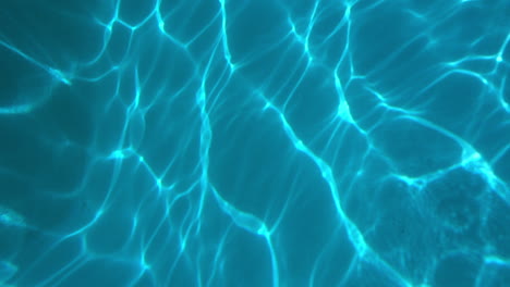 Wave-patterns-play-across-surface-of-swimming-pool-bottom