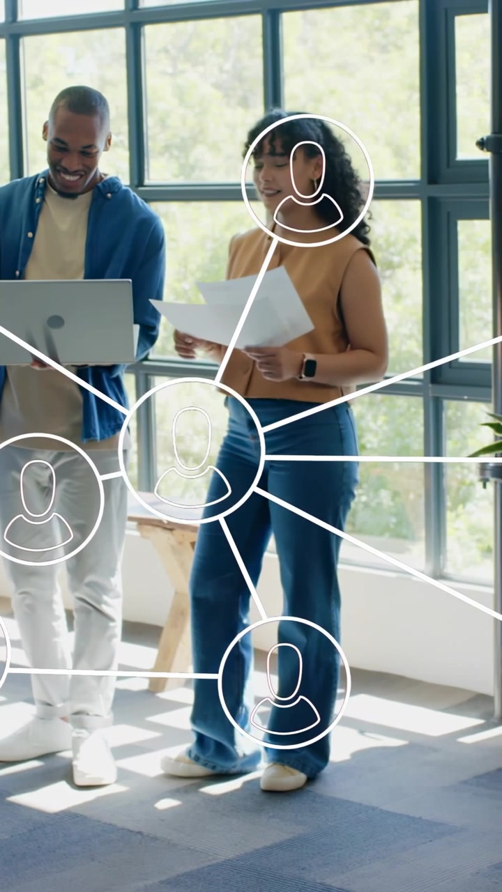 Vertical video: Raising papers, woman sharing at office with network graphic, man showing laptop