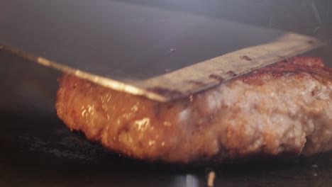 cooking american fat smash burger on grill close-up. beef or pork cutlet smashing by burger press. the chef in kitchen of the restaurant making cutlets for burgers - smash burger beefsteak. fast and street food concept. high quality 4k footage