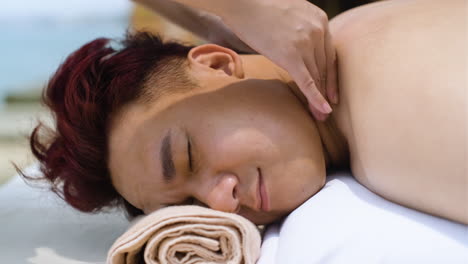 masseuse giving massage to man