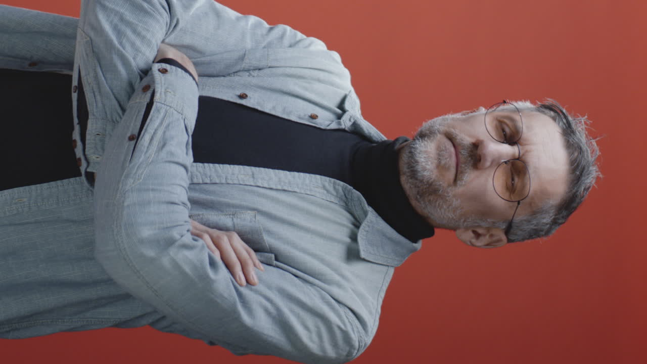 Man with arms crossed, looking serious