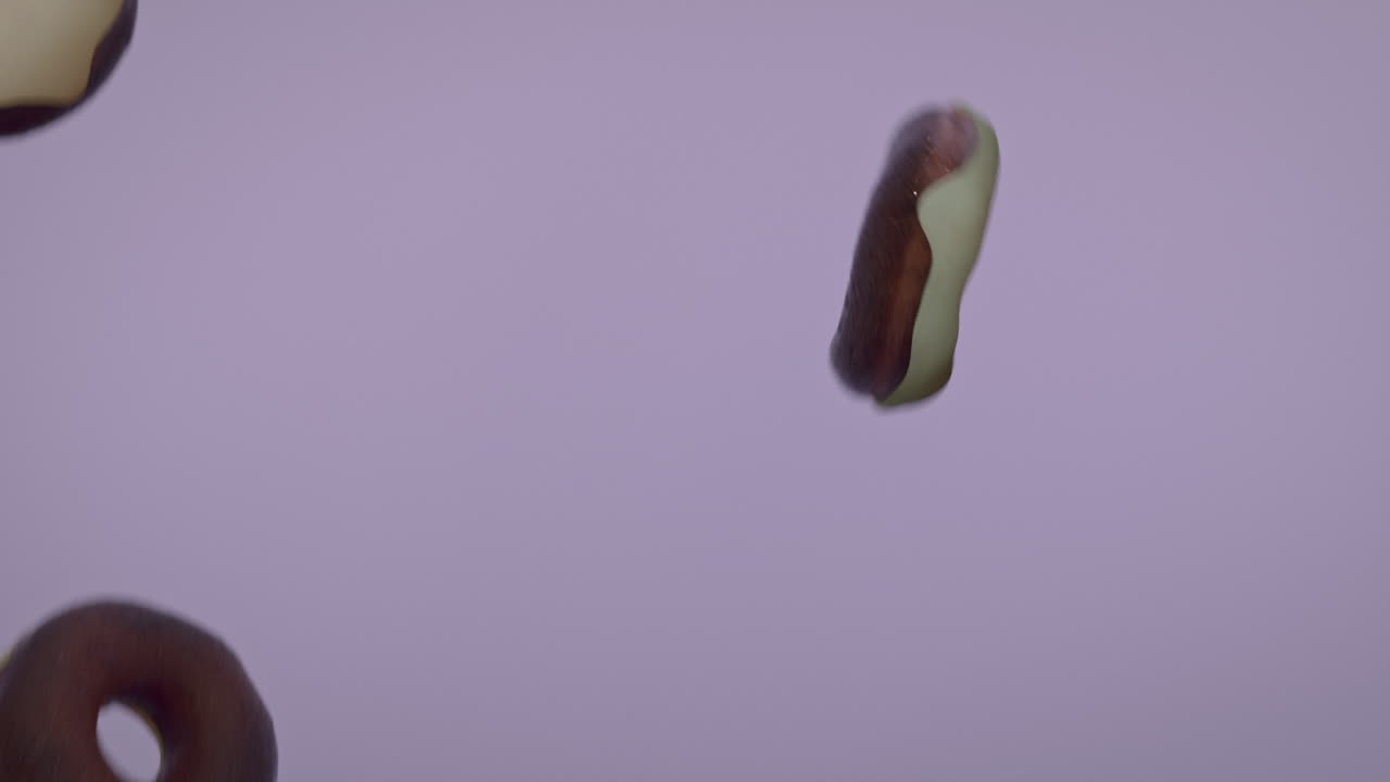 White glaze donuts on a light violet background
