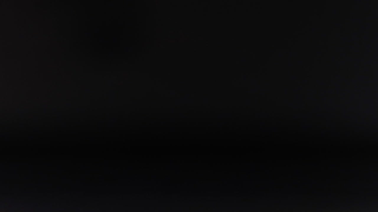 una pelota rosa se mueve contra un fondo oscuro