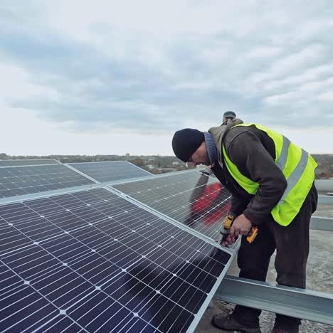 sunny cells installation. technician attaching blue solar panel to the metal construction. innovative technologies in receiving eco electricity.