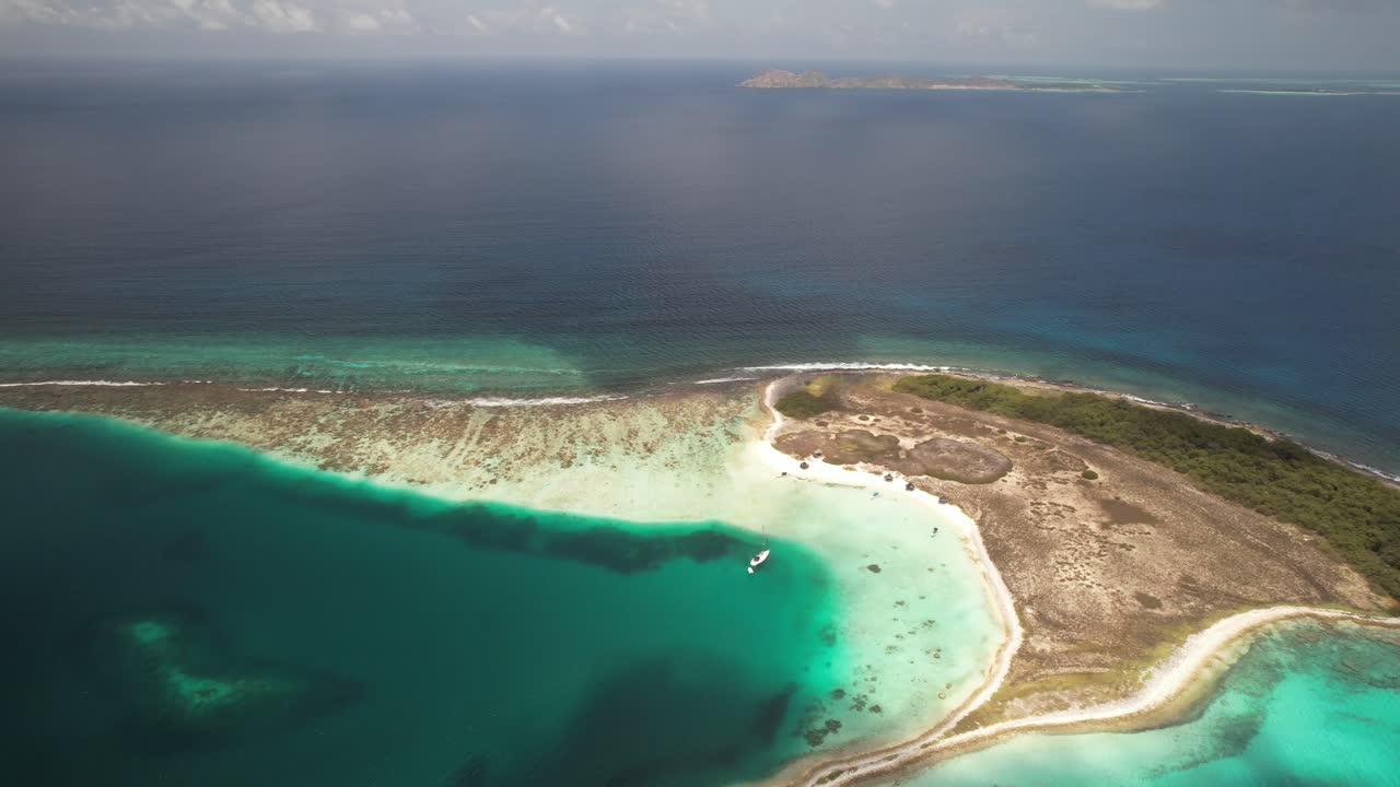 Vibrant turquoise waters and sandy shores of noronky island in los roques, aerial view