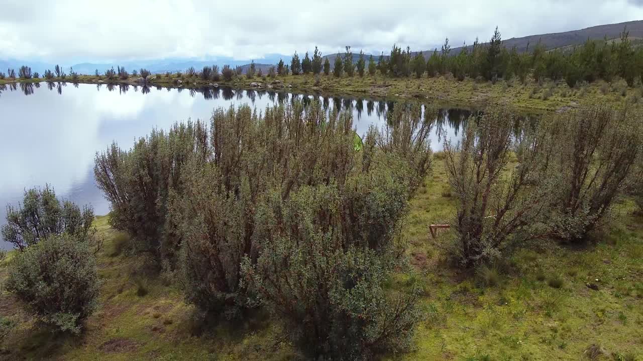 Drone Fly Over People At The Lakeshore With Still Water In Huaraz, Peru. Aerial Shot