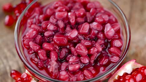 portion of preserved pomegranate seeds on a rotating plate (seamless loopable)