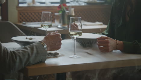 Couple on a Date in Molecular Cuisine Cafe Couple on a Date in Molecular Cuisine Restaurant two Delicious Dishes with Dry Ice Steam on Table Man and Woman Sit in Modern Gastro Cafe together Drink Wine and Talk Concept of Public Catering
