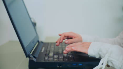 close-up of hands typing