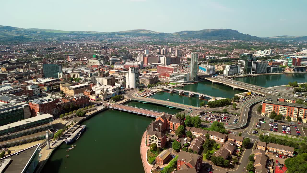 Ultra-wide reversing aerial GV of Belfast City Centre, Northern Ireland, UK on a bright and sunny day. Produced in 4K, 60FPS and with Rec709 color