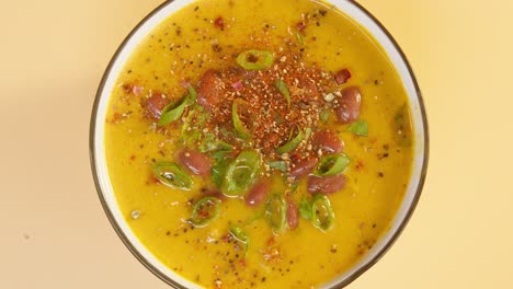 sprinkling spices on bean soup close-up rotating. arabian cuisine. traditional middle eastern culture. vegetarian homemade food concept, healthy eating