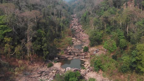 Wide-shot-of-Song-Sa-Waterfall-at-Laos-during-dry-season,-aerial