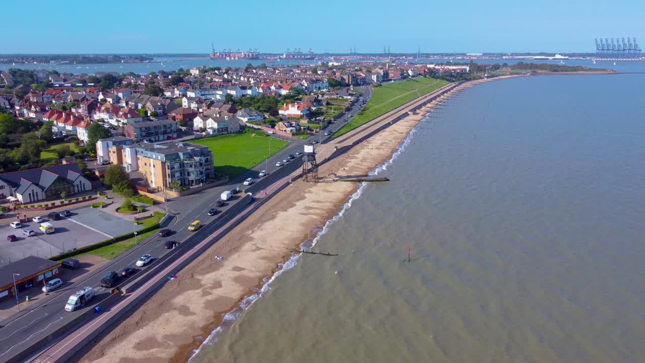 aerial view of Harwich town in Essex, England coastline with ocean sandy beach and traffic on main road traditional old English village drone footage