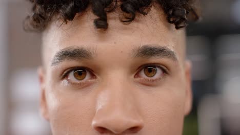 Portrait-close-up-of-eyes-of-biracial-creative-businessman-smiling-in-office,-in-slow-motion