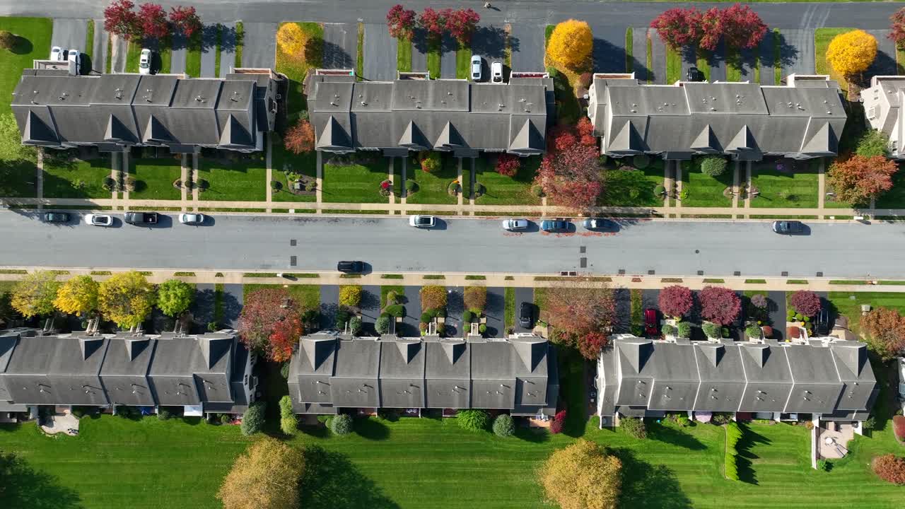 fila de casas suburbanas con coloridos árboles de otoño