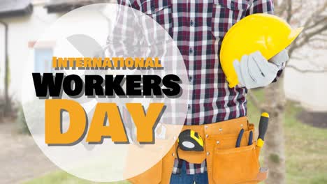 Animation-of-international-workers-day-text-over-caucasian-male-worker-with-hammer-and-helmet