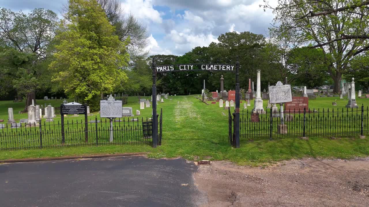 Drone footage, moving slightly toward the entrance of Paris City Cemetery located in Paris Tennessee
