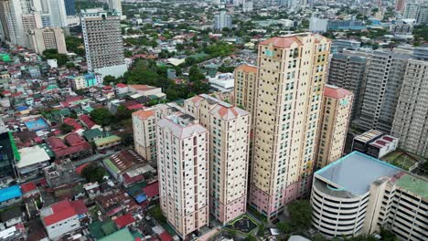 aerial dolly shot of towering apartment buildings in a highly urbanized area of san juan city, manila, philippines