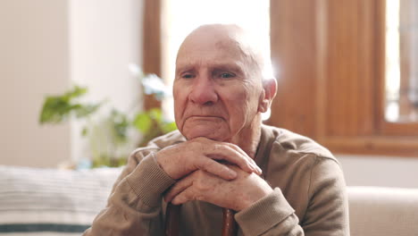 thinking, sad and senior man on sofa in home