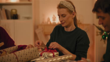 young friends wrapping christmas gifts together