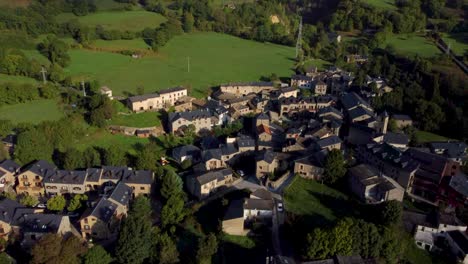 A-drone-revealing-shot-of-the-Eriste-town-in-Spain,-showing-the-town-itself-and-the-mountains-at-the-end