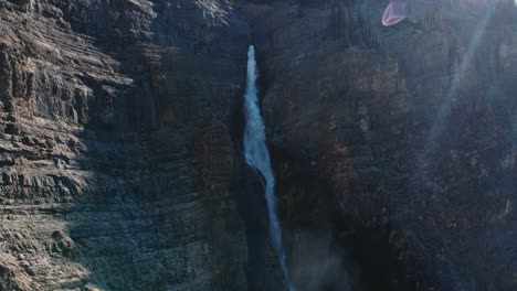 large waterfall gushing with mist pulling out