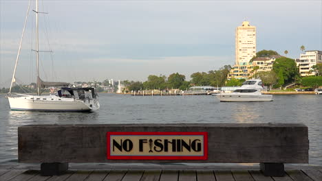 a no fishing sign next to sydney harbour