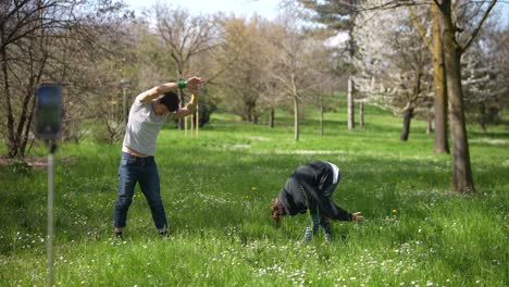couple stretching and exercising in a park