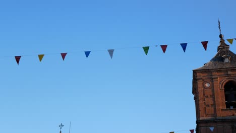 panning right from festival decoration to the tower of san juan bautista church in ávila, spain