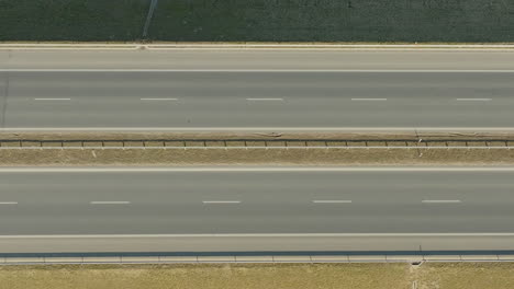 top-down view of a car driving on a highway with clear lane markings