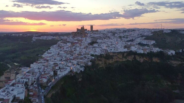 White town on cliff at sunset