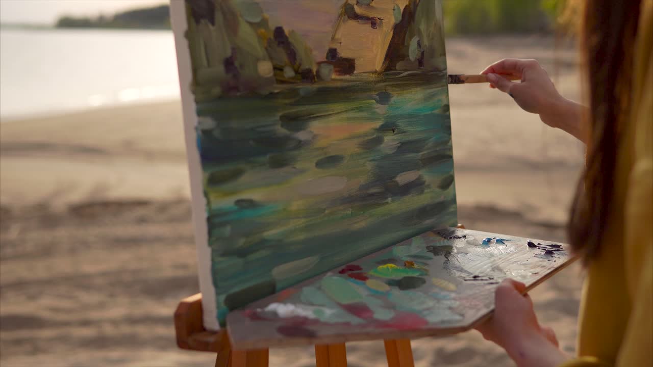 Artist painting a landscape on the beach