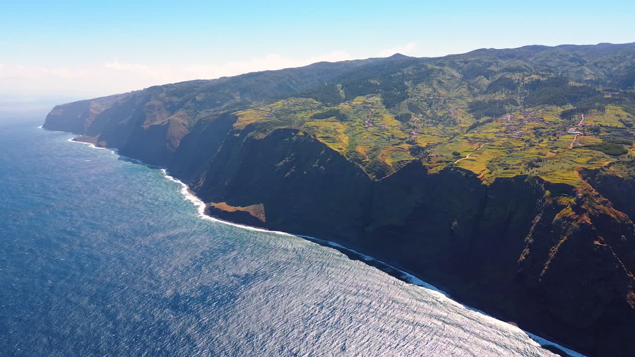 Stunning huge rocks with unapproachable cliffs at the Atlantic Ocean waterscape. Sunny view of the shore of Madeira, Portugal. Top perspective.
