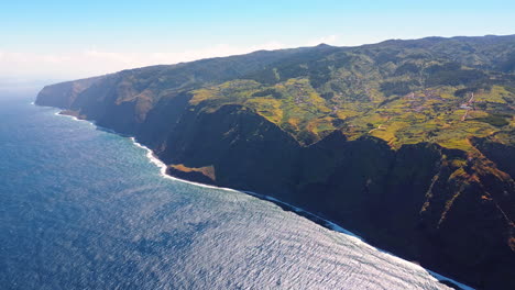 stunning huge rocks with unapproachable cliffs at the atlantic ocean waterscape. sunny view of the shore of madeira, portugal. top perspective.