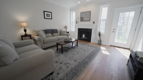 comfortable living room with cozy sofa set in a modern real estate housing - forward shot